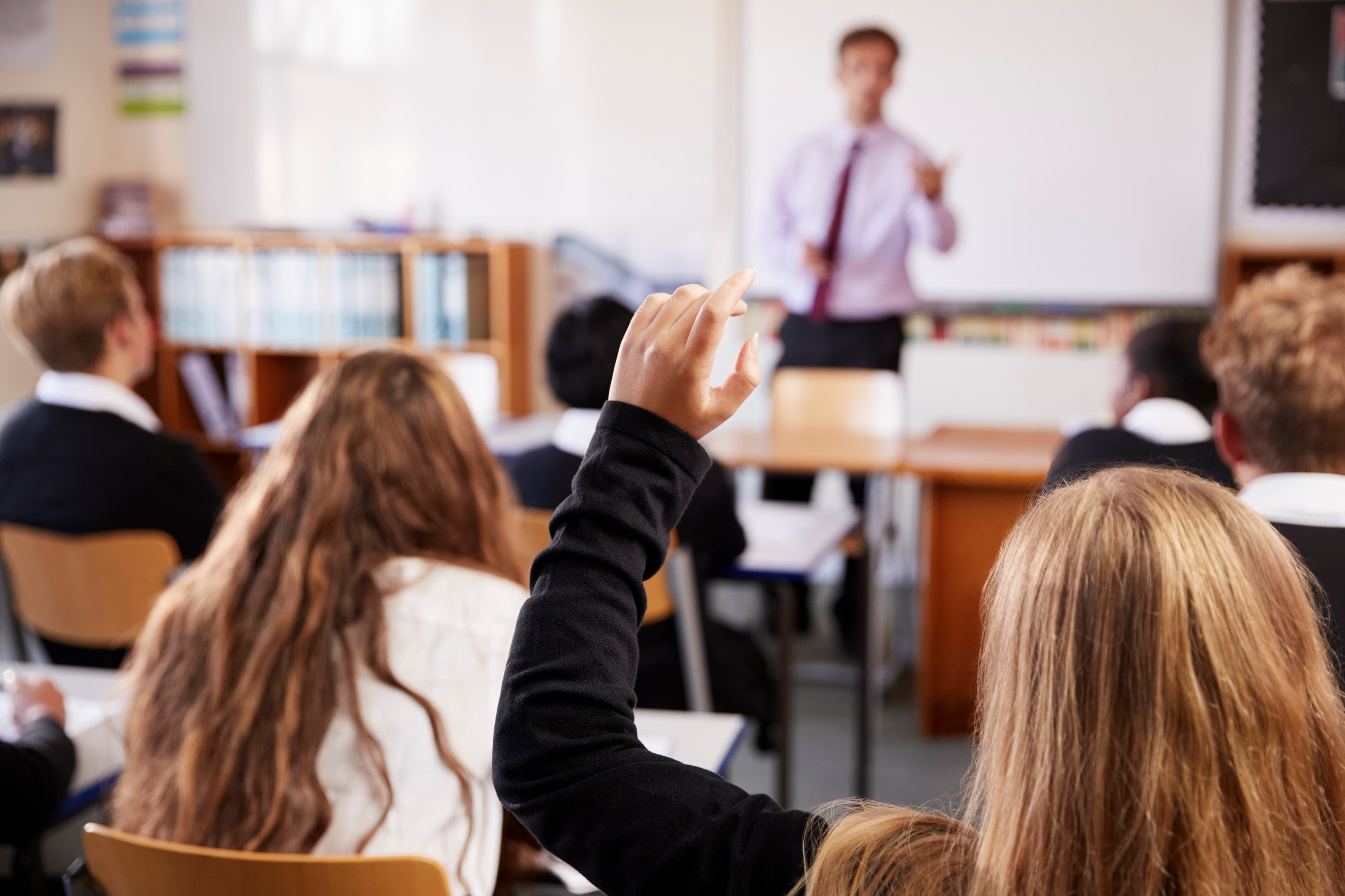 A lesson with a student raising their hand.